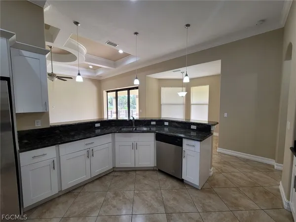 a large white kitchen with a stove and a sink