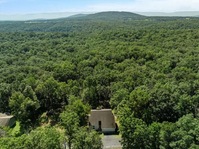 an aerial view of a house with a yard