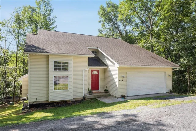 a view of a lush green hillside and a houses