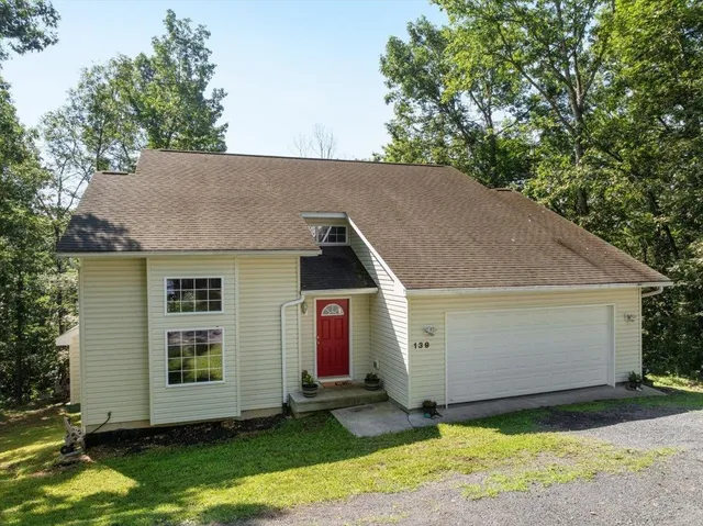 a view of front of house with a yard