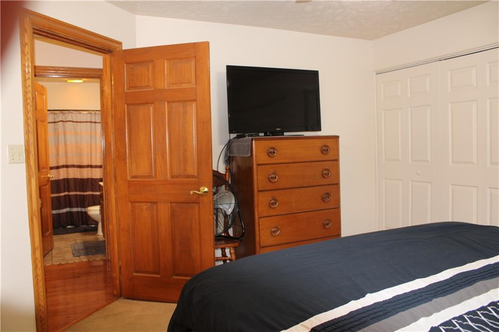 125 Shannon Road Renfrew, PA 16053 - Photo 13 of 39 a bedroom with a bed and flat screen tv