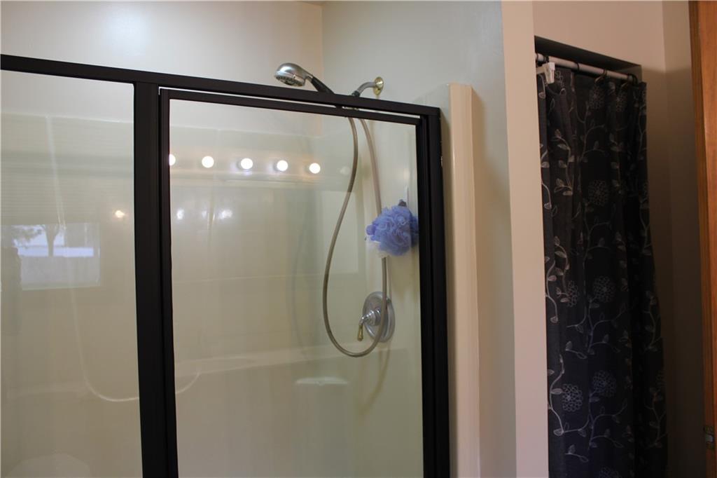 125 Shannon Road Renfrew, PA 16053 - Photo 20 of 39 a bathroom with a glass shower door and mirror