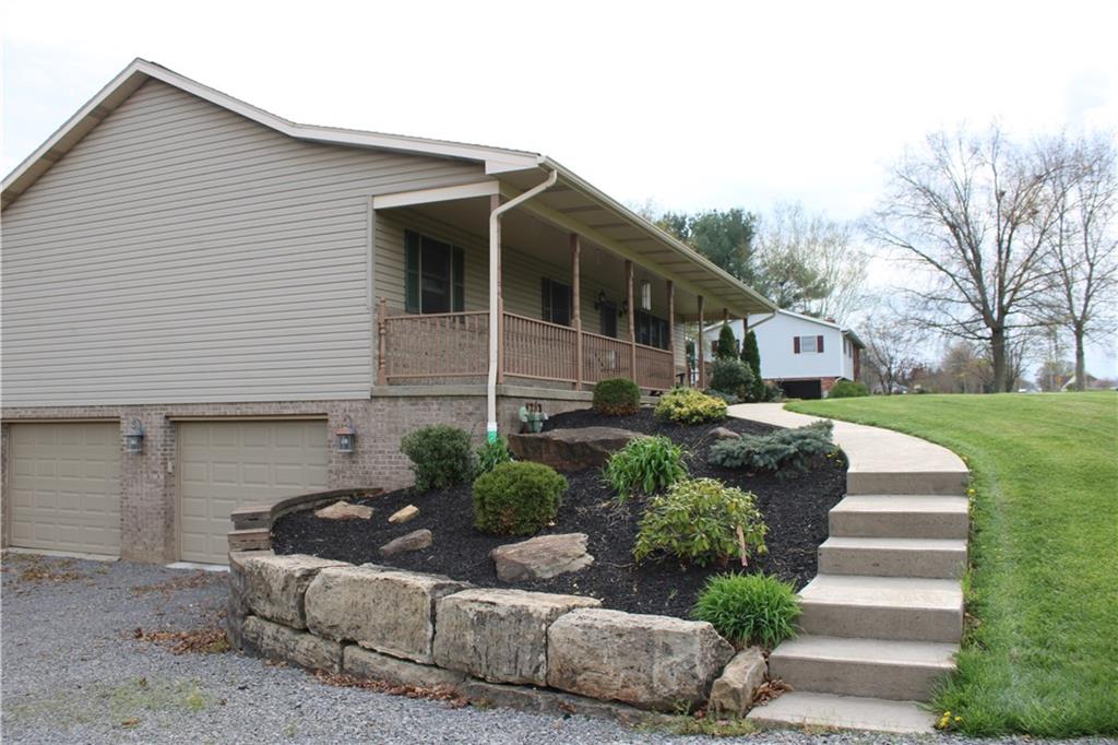 125 Shannon Road Renfrew, PA 16053 - Photo 2 of 39 a front view of a house with a yard and potted plants