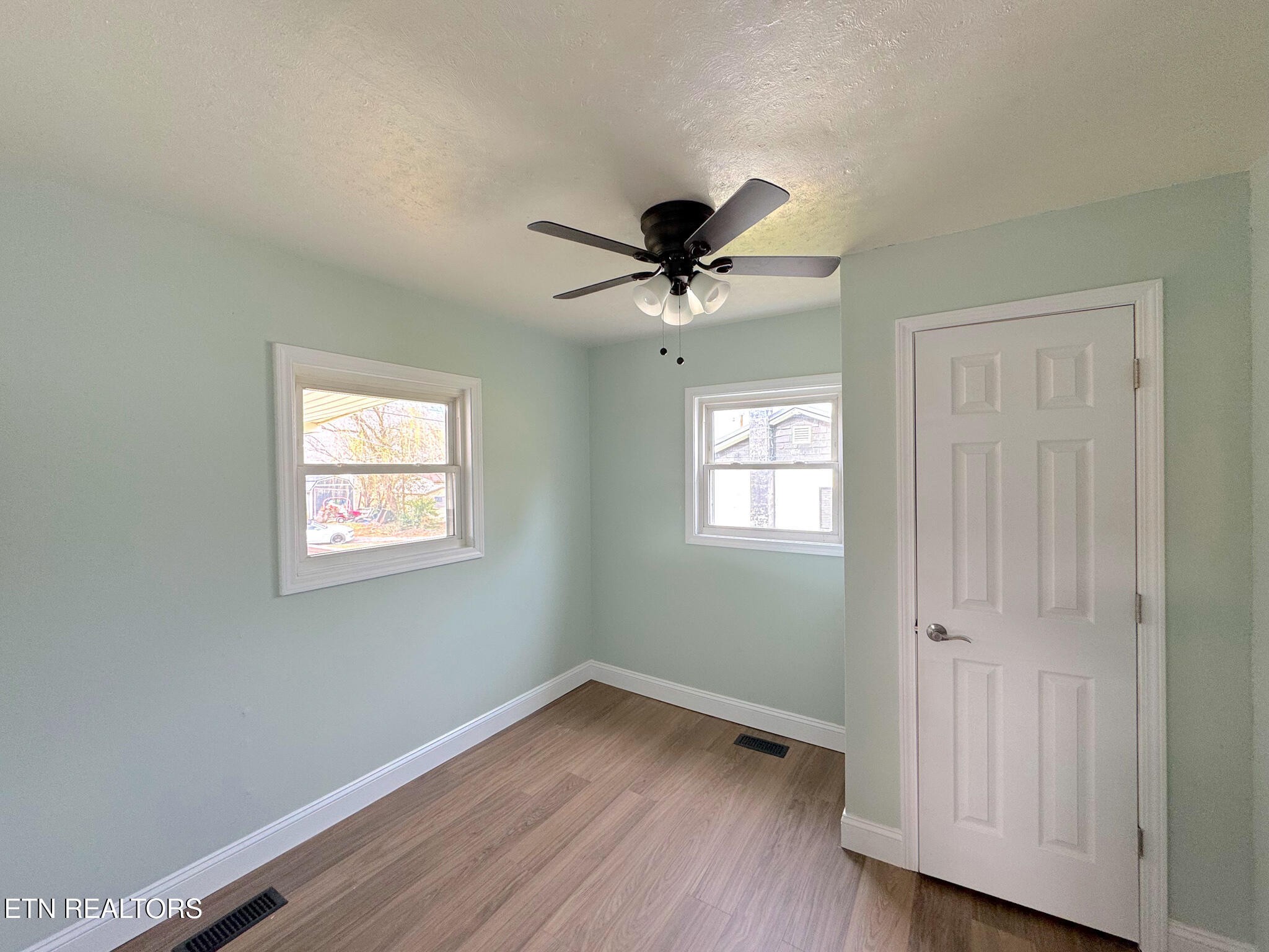 150 Connor Street Jacksboro, TN 37757 - Photo 11 of 22 a view of an empty room with wooden floor and a window