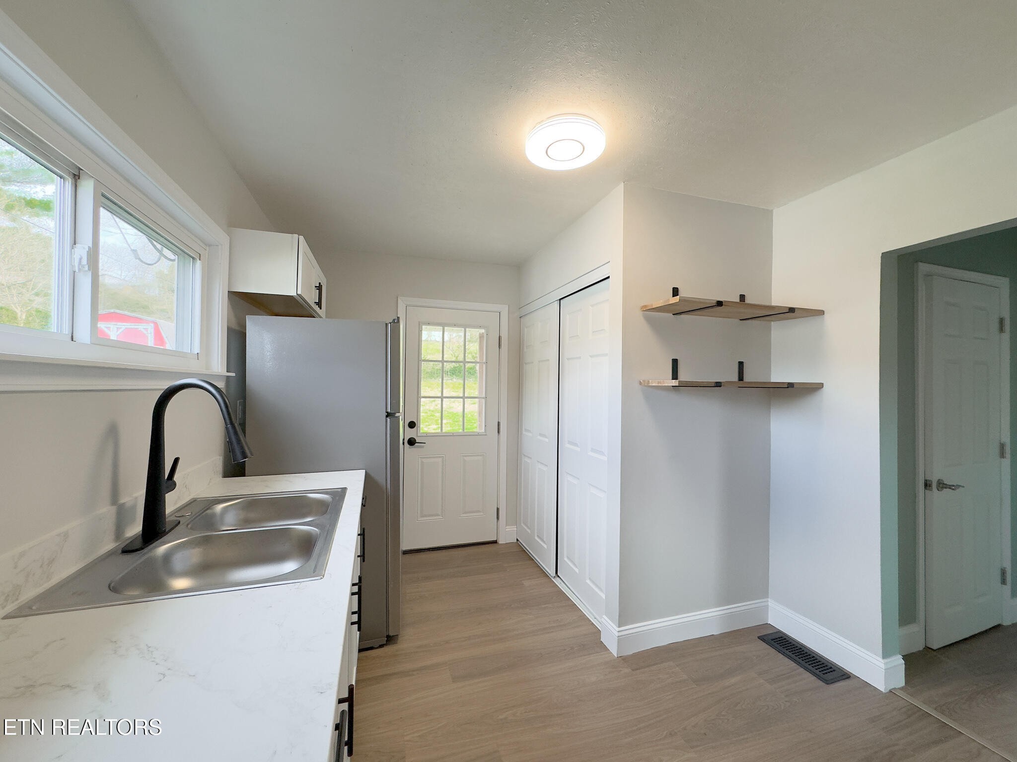 150 Connor Street Jacksboro, TN 37757 - Photo 6 of 22 a kitchen with a refrigerator and sink