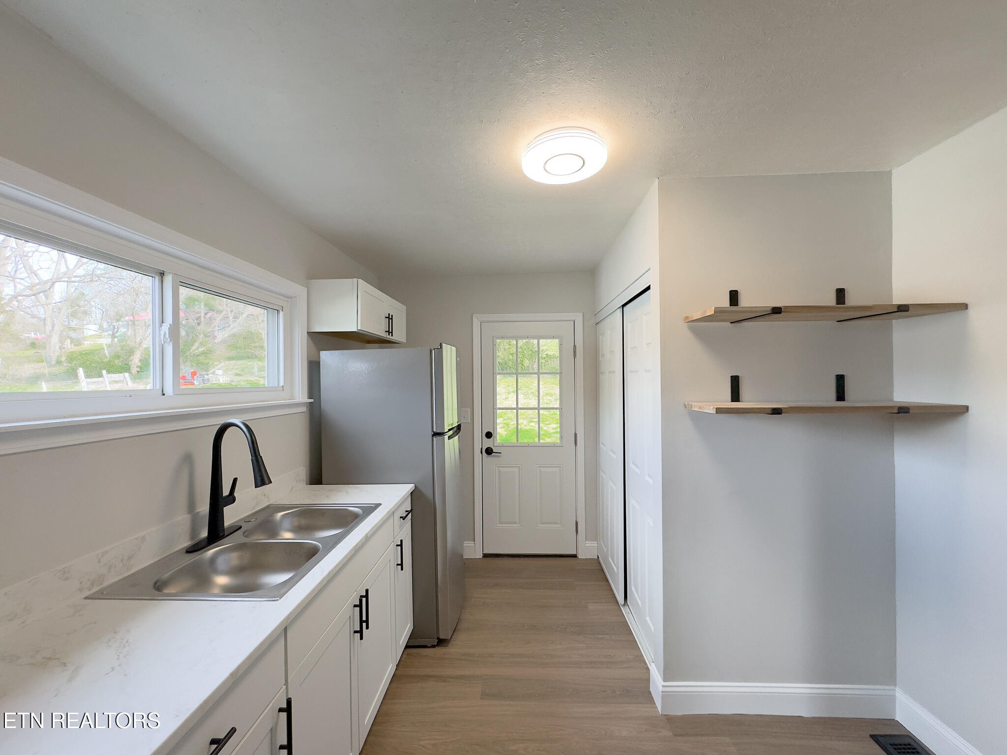150 Connor Street Jacksboro, TN 37757 - Photo 8 of 22 a kitchen with granite countertop a sink stove and refrigerator