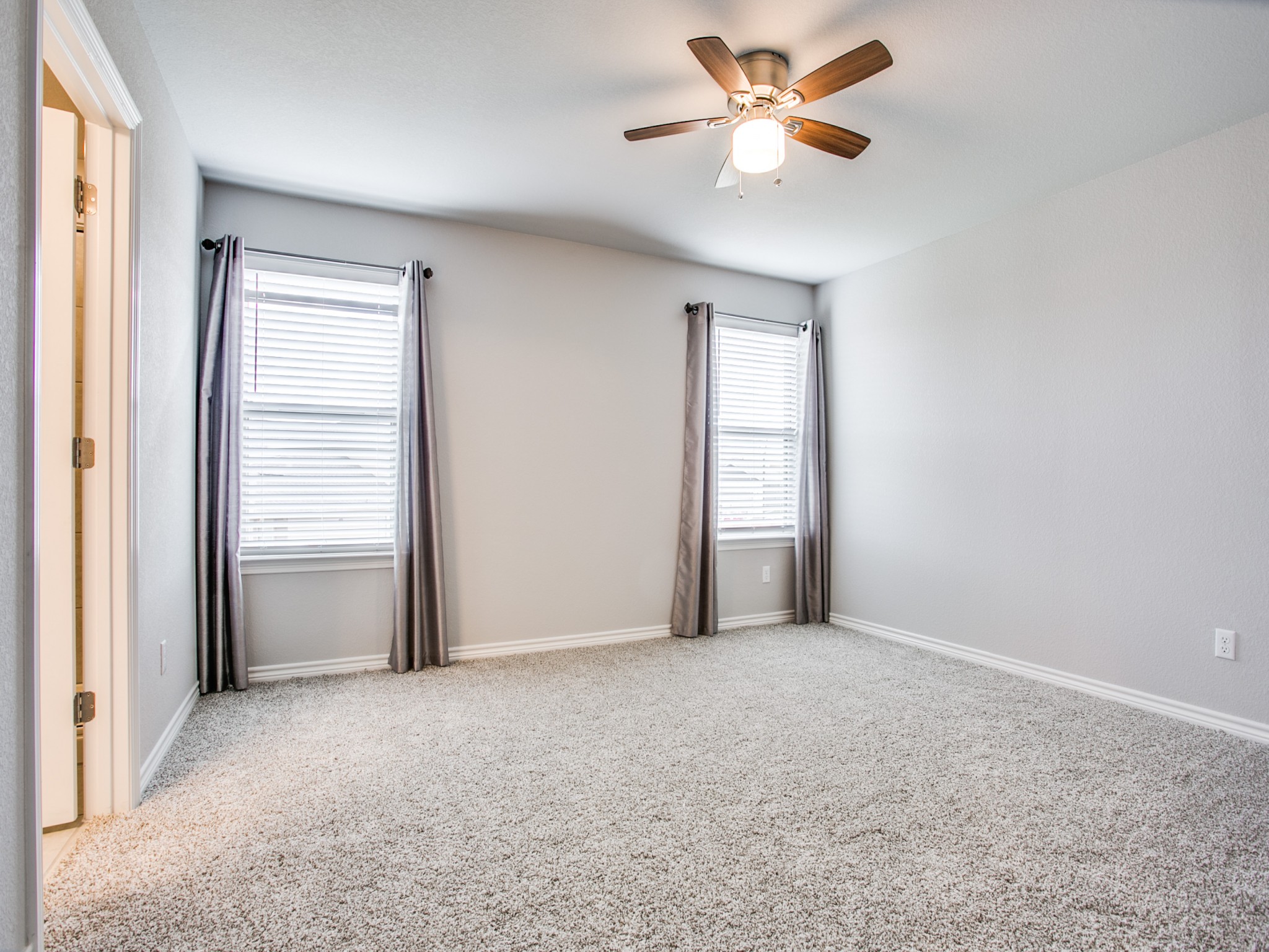 508 Rearing Mare Pass Georgetown, TX 78626 - Photo 14 of 26 Carpeted main bedroom with a ceiling fan and baseboards