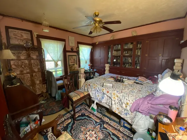 a bed room with a bed window and dresser