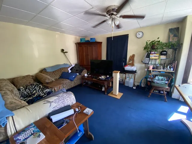 a living room with furniture gym equipment and a window
