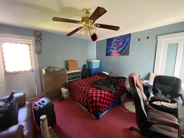 a bedroom with furniture and a window