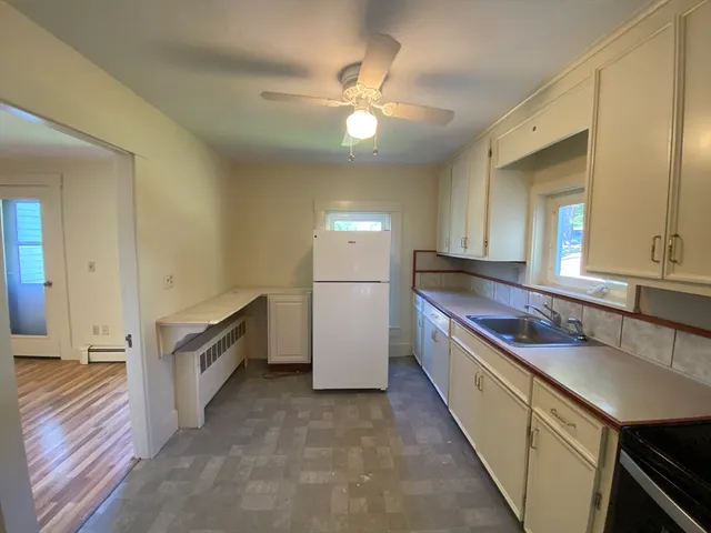 a kitchen with stainless steel appliances a sink and a refrigerator