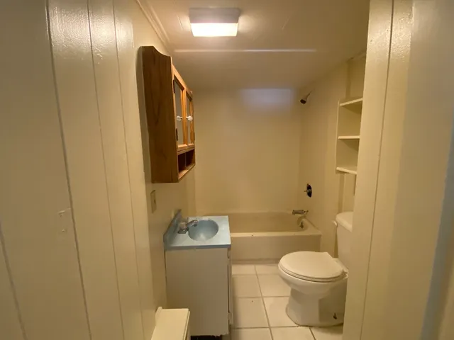 a bathroom with a toilet a sink and bathtub