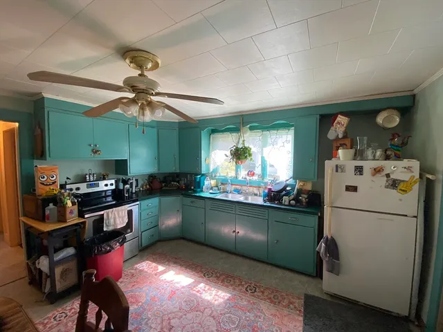 a kitchen with refrigerator and cabinets