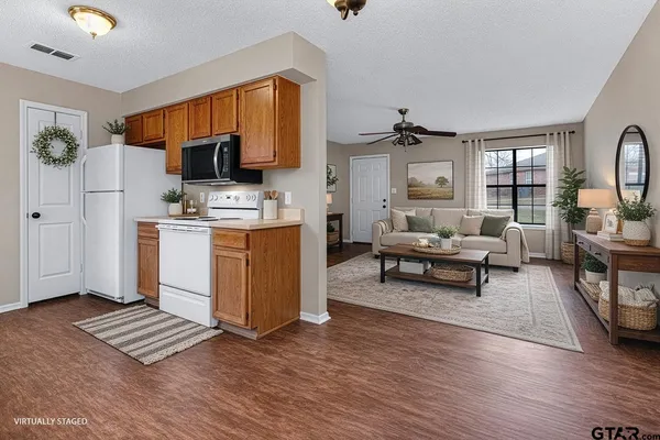 a living room with furniture a rug and a flat screen tv