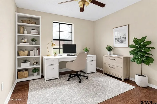 a view of a workspace with furniture and a potted plant