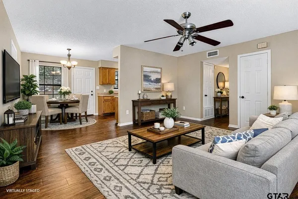 a living room with furniture and wooden floor