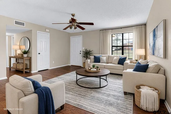 a living room with furniture and wooden floor