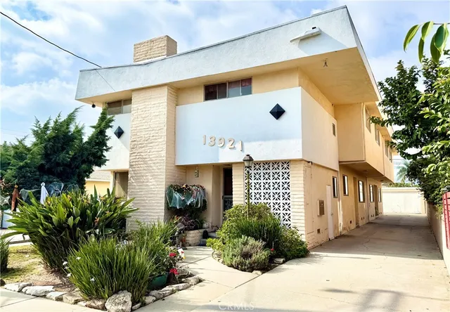 a front view of a house with plants