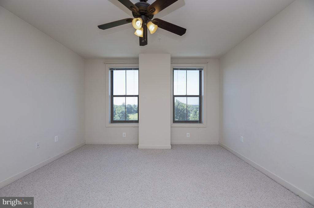 485 Harbor Side Street, Unit 710 Woodbridge, VA 22191 - Photo 14 of 26 an empty room with windows and chandelier fan