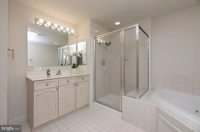 a bathroom with a shower sink vanity and mirror