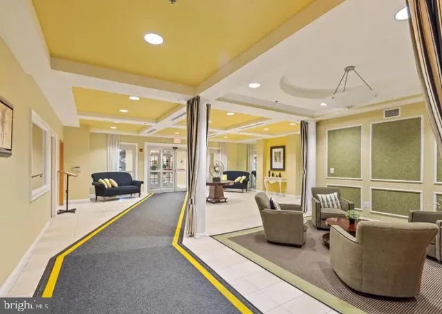 a living room with furniture a flat screen tv and a large window