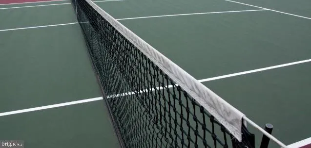 a view of ocean with boats and trees in the background