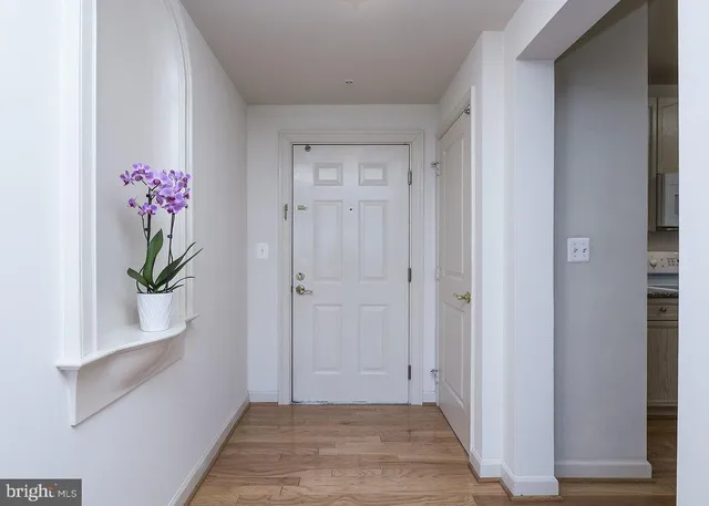 a view of hallway with wooden floor