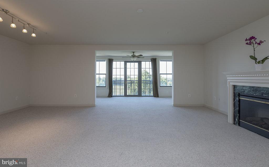 485 Harbor Side Street, Unit 710 Woodbridge, VA 22191 - Photo 4 of 26 a view of an empty room with a fireplace