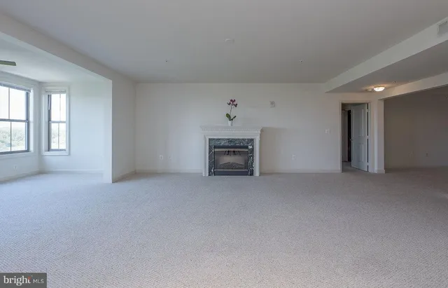 an empty room with furniture and a fireplace