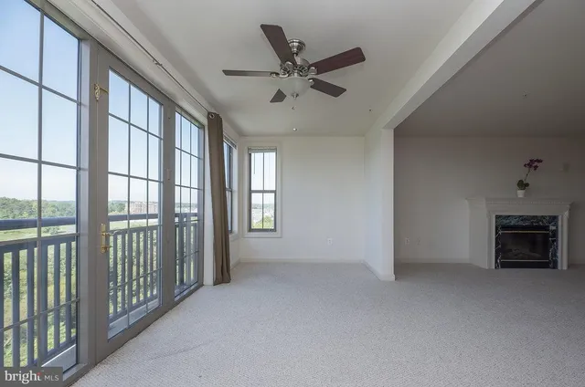 a view of a livingroom with a ceiling fan and window