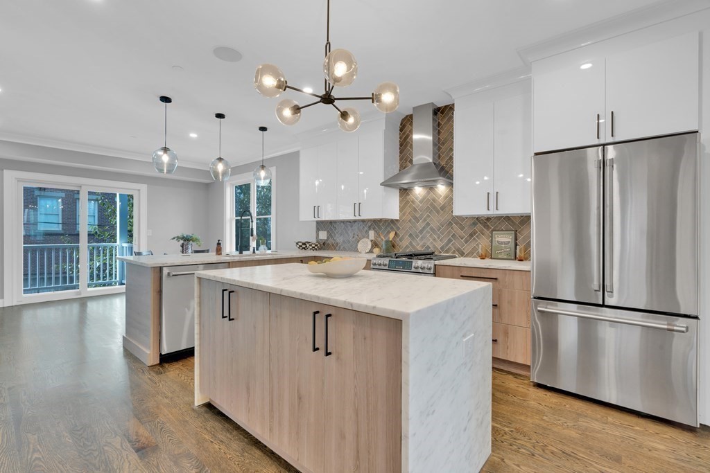 87 Parkton Road, Unit 2 Boston, MA 02130 - Photo 4 of 37 a kitchen with kitchen island white cabinets and stainless steel appliances