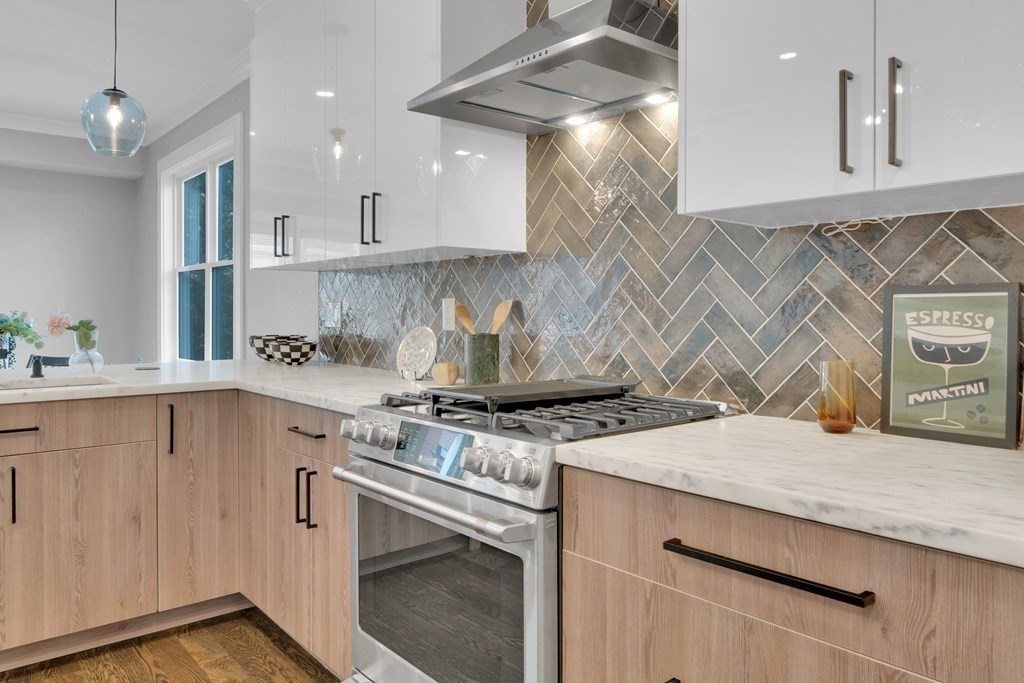 87 Parkton Road, Unit 2 Boston, MA 02130 - Photo 5 of 37 a kitchen with a stove and a white cabinets