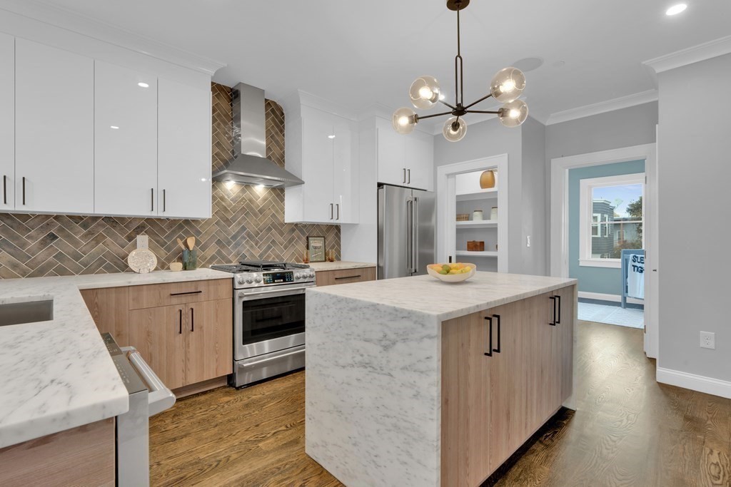87 Parkton Road, Unit 2 Boston, MA 02130 - Photo 6 of 37 a kitchen that has a lot of white cabinets and stainless steel appliances