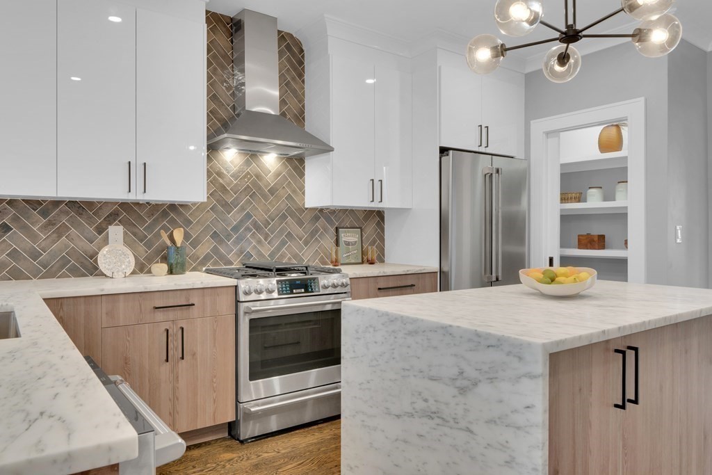 87 Parkton Road, Unit 2 Boston, MA 02130 - Photo 7 of 37 a kitchen with stainless steel appliances granite countertop a stove a refrigerator and a sink