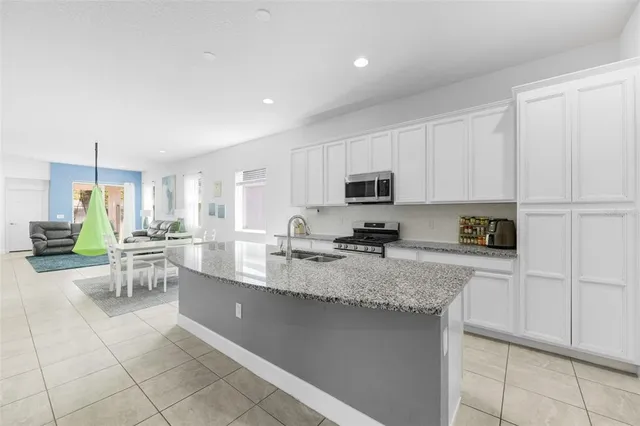 a kitchen with stainless steel appliances granite countertop a sink and cabinets