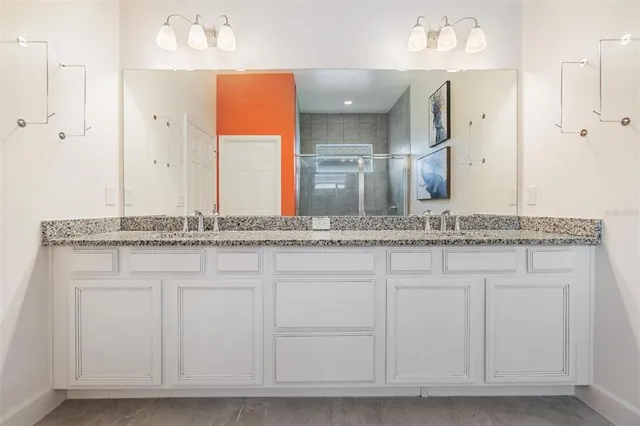 a bathroom with a granite countertop toilet a sink and a bathtub