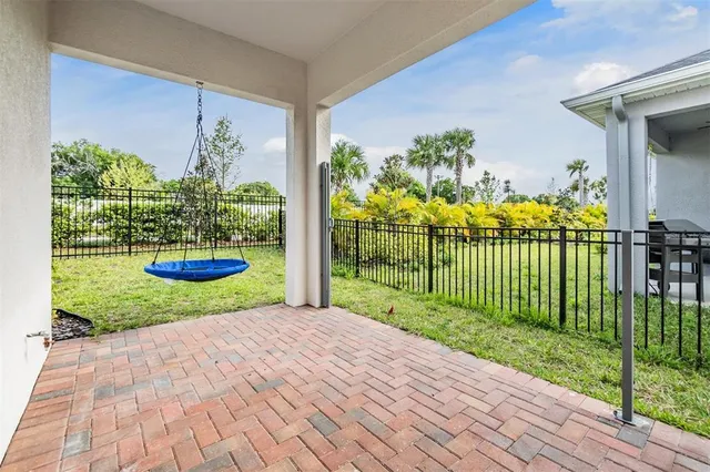 an aerial view of residential houses with outdoor space and river