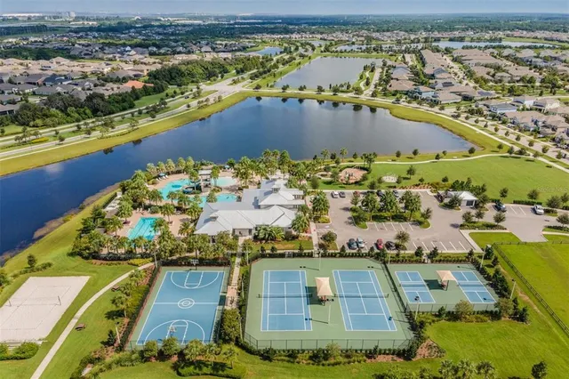 an aerial view of a swimming pool with outdoor seating and yard