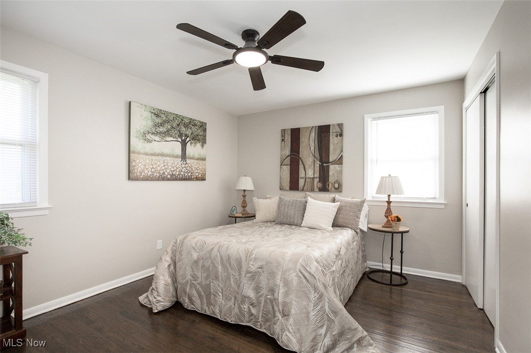 4631 Belfiore Road Cleveland, OH 44128 - Photo 11 of 28 Bedroom featuring dark wood-style floors, a ceiling fan, a closet, and multiple windows