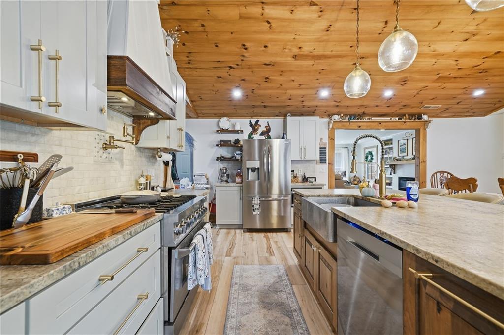 34 Bodie Road Talking Rock, GA 30175 - Photo 11 of 49 a kitchen with stainless steel appliances granite countertop a sink a stove and cabinets