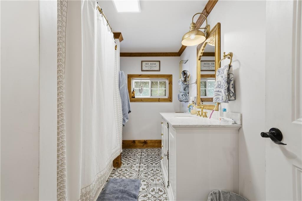 34 Bodie Road Talking Rock, GA 30175 - Photo 25 of 49 a bathroom with a sink and a mirror