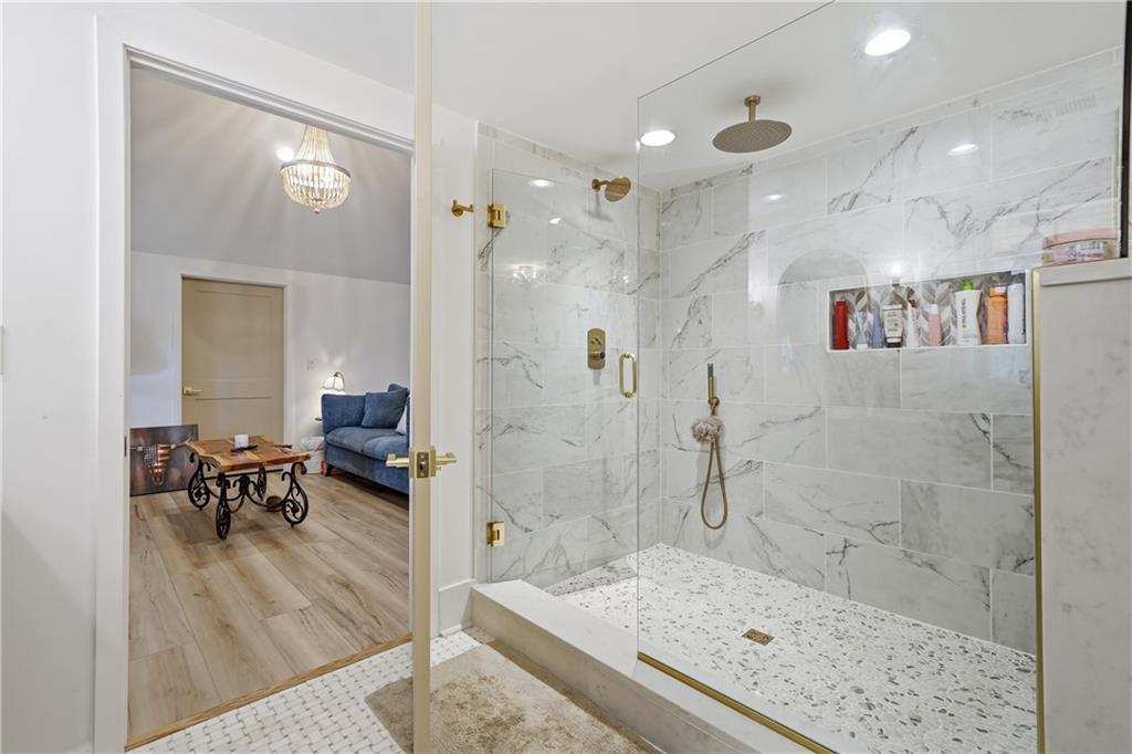 34 Bodie Road Talking Rock, GA 30175 - Photo 26 of 49 a spacious bathroom with a granite countertop shower a sink and a mirror