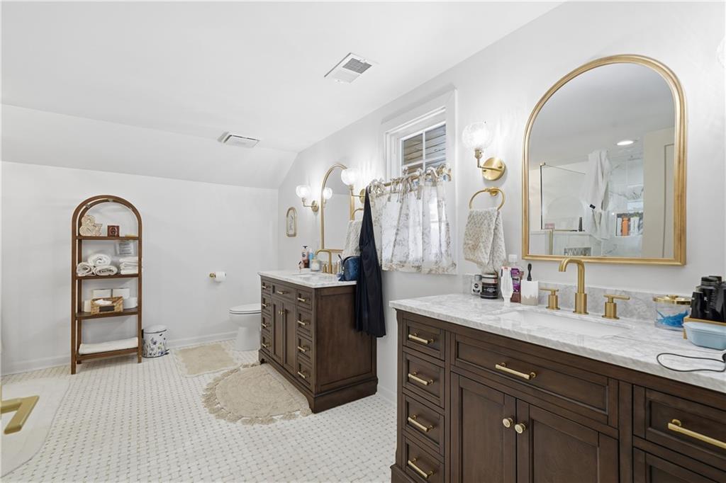 34 Bodie Road Talking Rock, GA 30175 - Photo 28 of 49 a spacious bathroom with a double vanity sink and a mirror