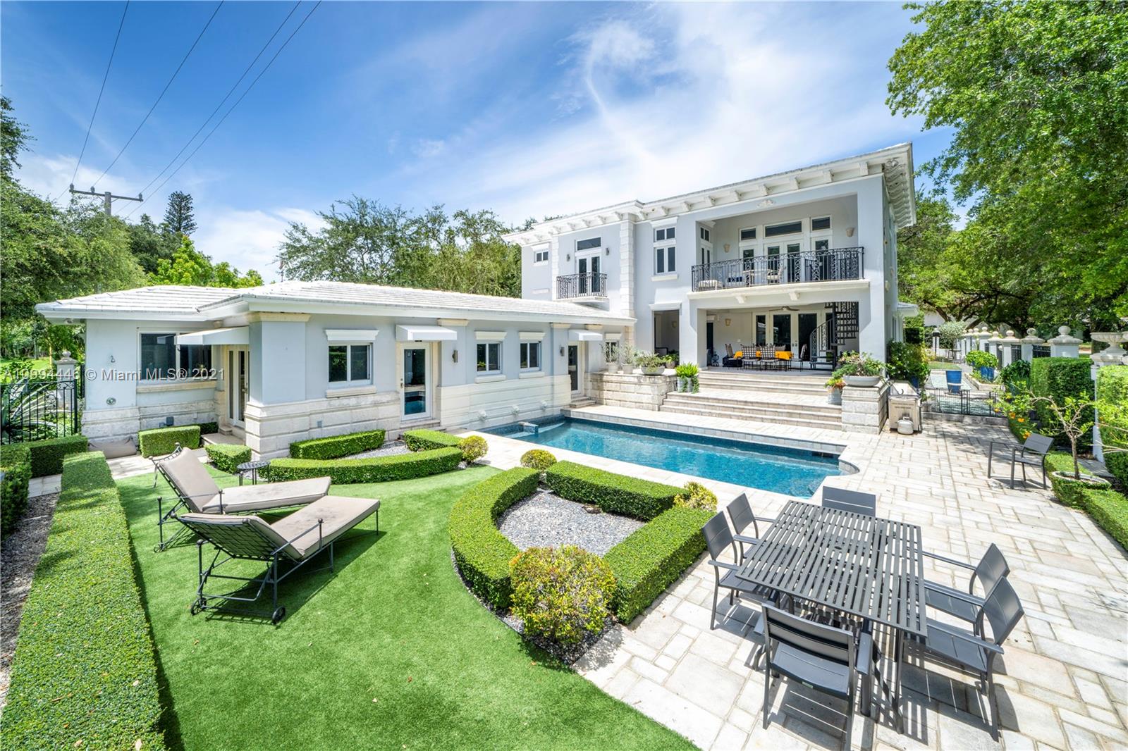 a view of a house with swimming pool and sitting area