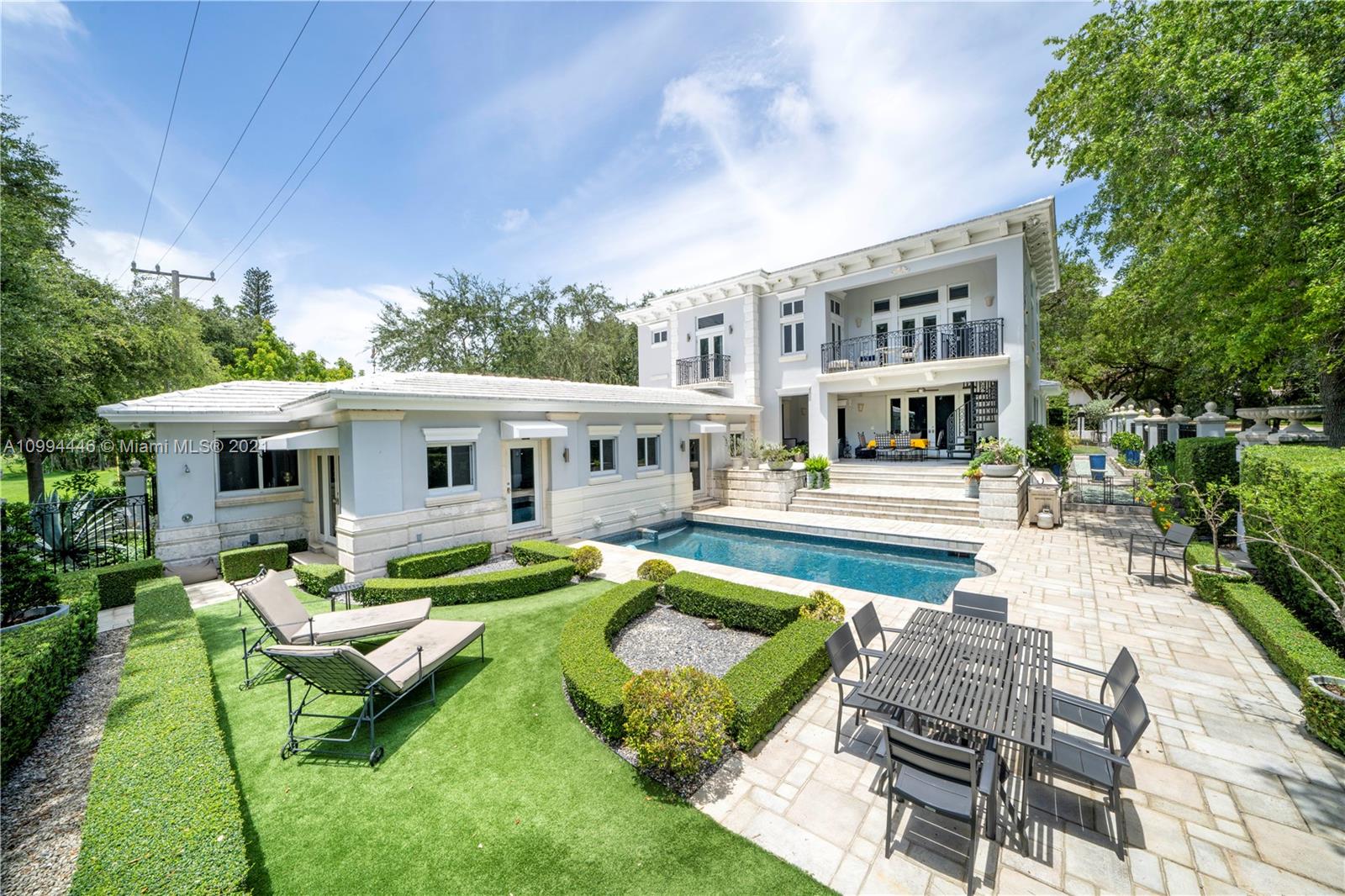 3916 Granada Boulevard Coral Gables, FL 33134 - Photo 12 of 75 a front view of a house with garden swimming pool and sitting area