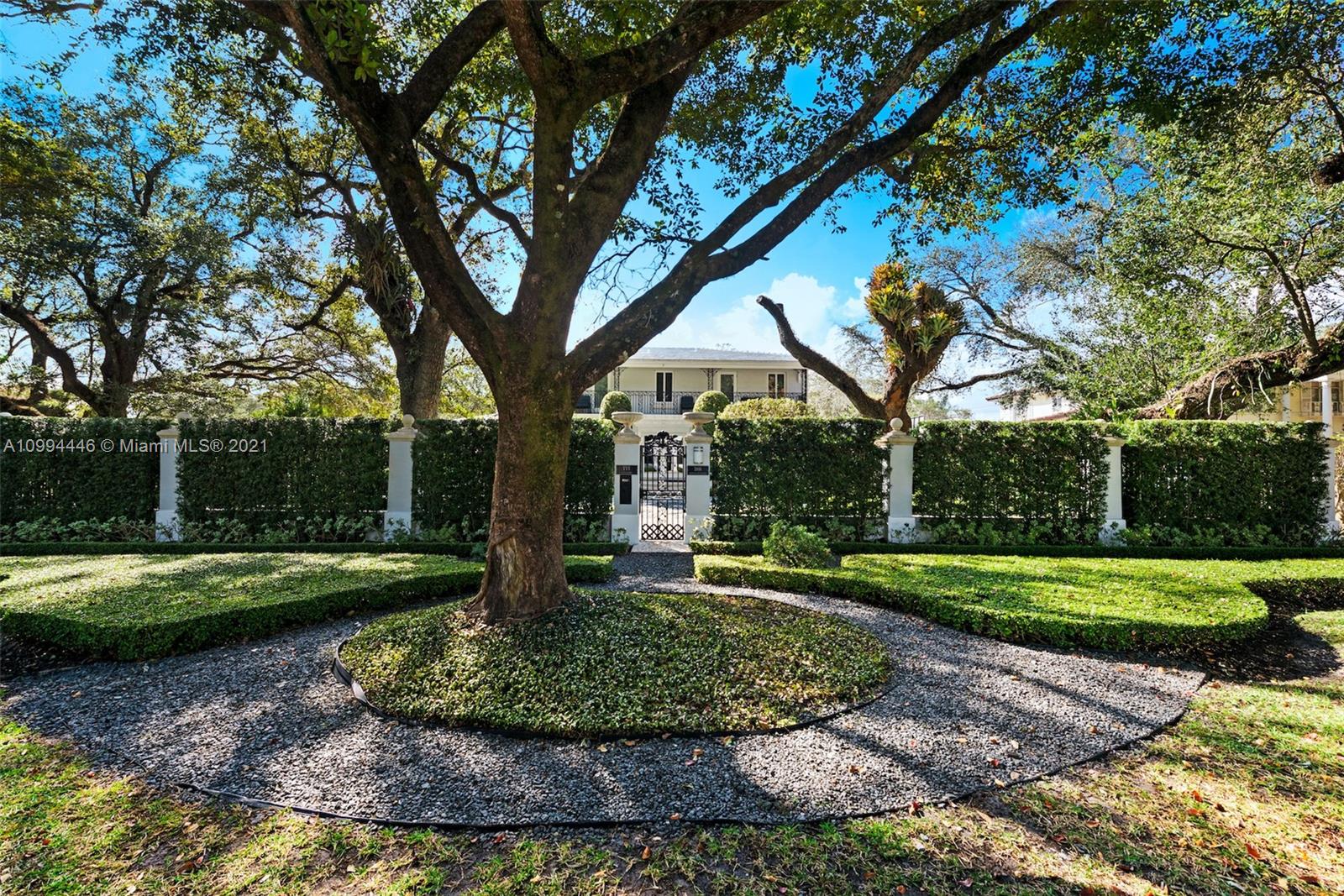 3916 Granada Boulevard Coral Gables, FL 33134 - Photo 13 of 75 a view of a backyard with large trees