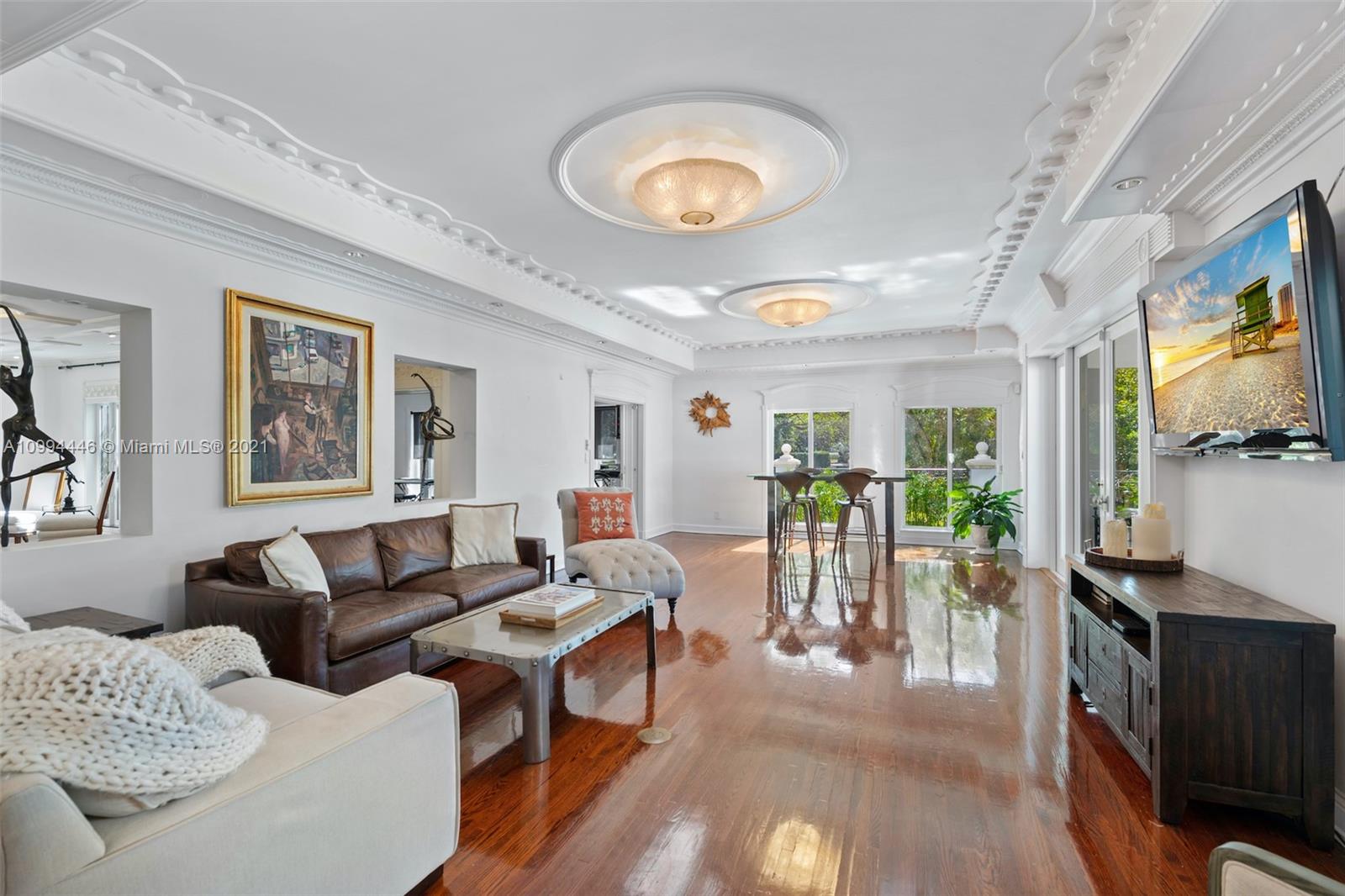 3916 Granada Boulevard Coral Gables, FL 33134 - Photo 20 of 75 a living room with furniture a flat screen tv and a large window