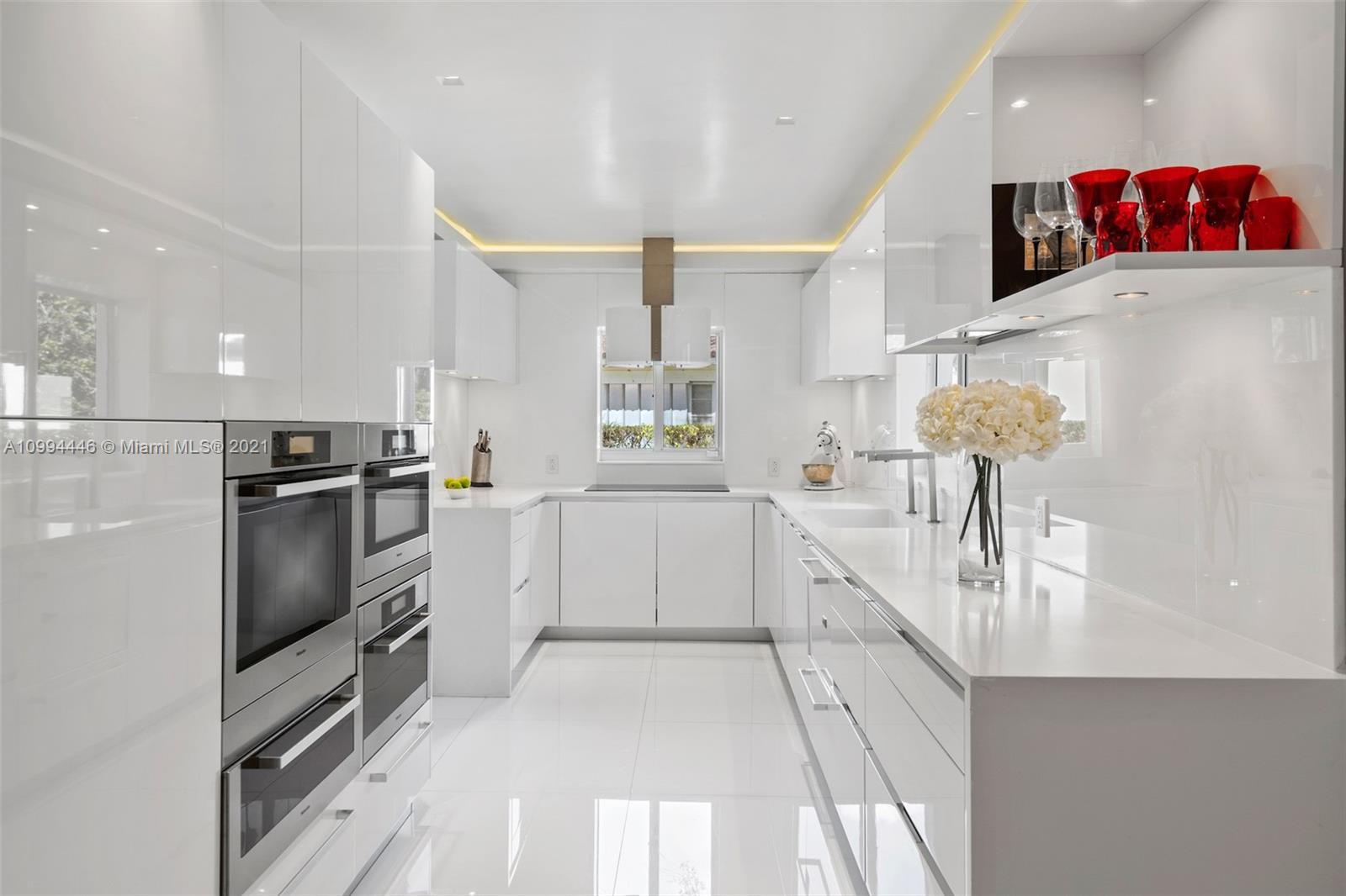 3916 Granada Boulevard Coral Gables, FL 33134 - Photo 24 of 75 a kitchen with granite countertop a refrigerator and a sink