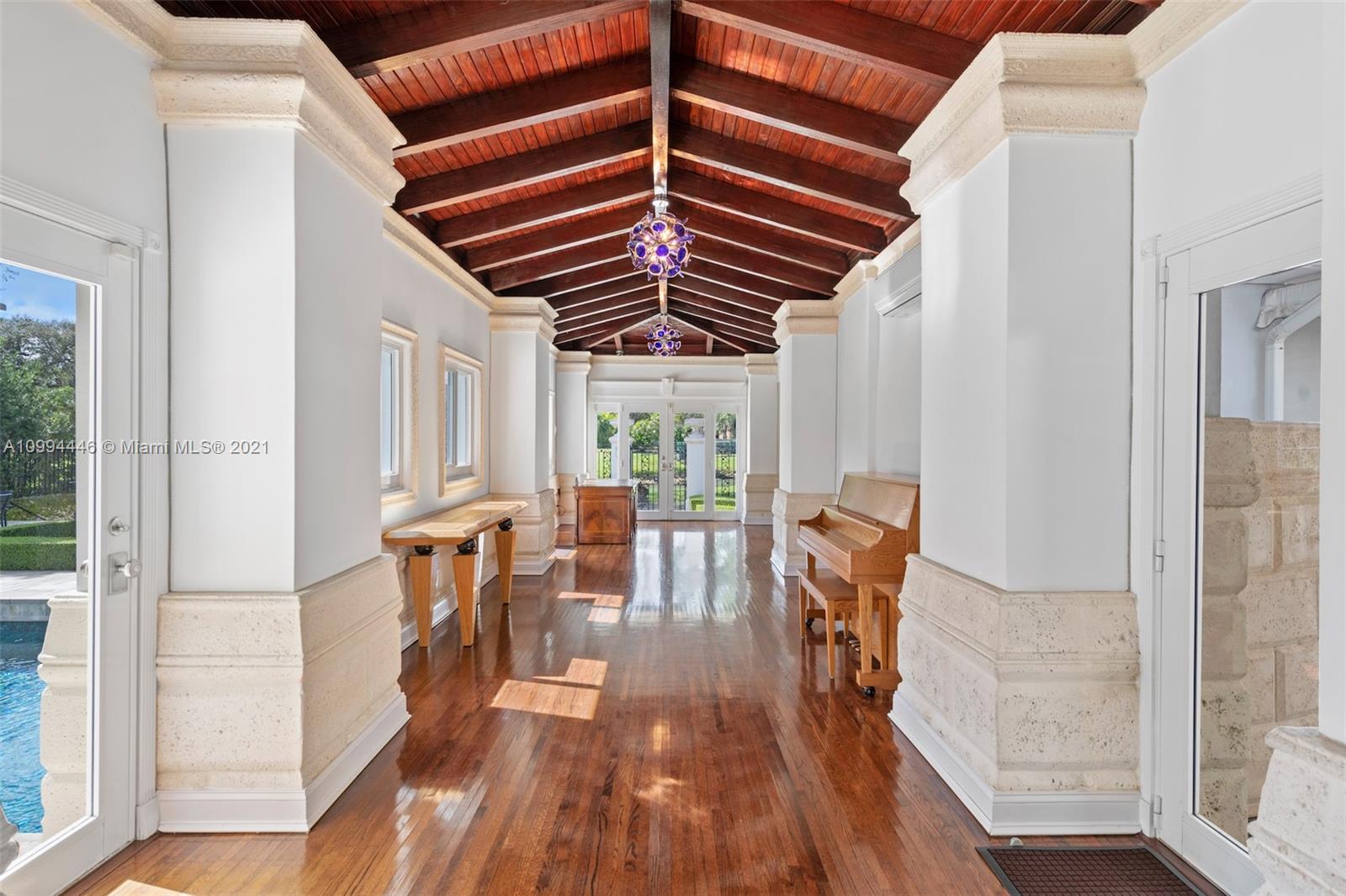 3916 Granada Boulevard Coral Gables, FL 33134 - Photo 34 of 75 a view of a hallway with wooden floor and furniture