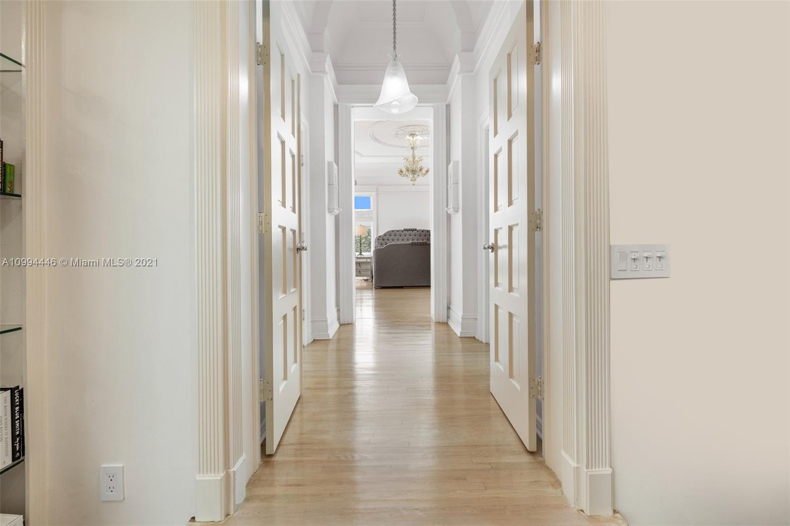 3916 Granada Boulevard Coral Gables, FL 33134 - Photo 41 of 75 a view of a hallway with wooden floor and staircase